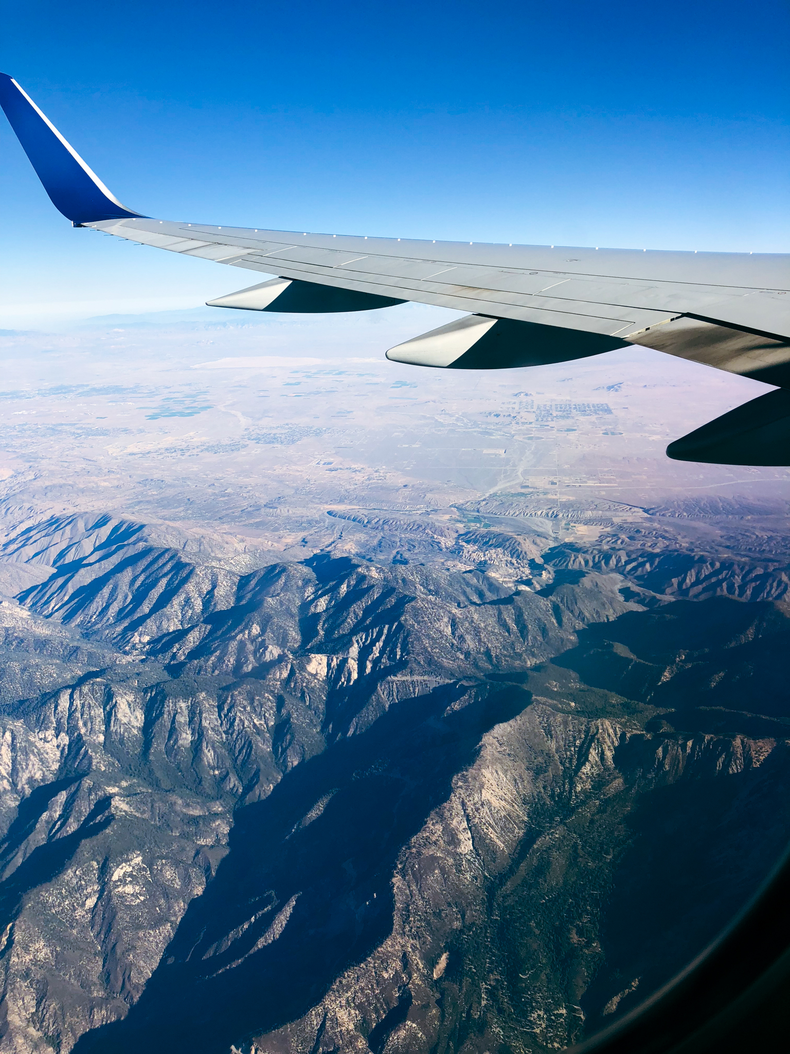 airplane flying over mountains